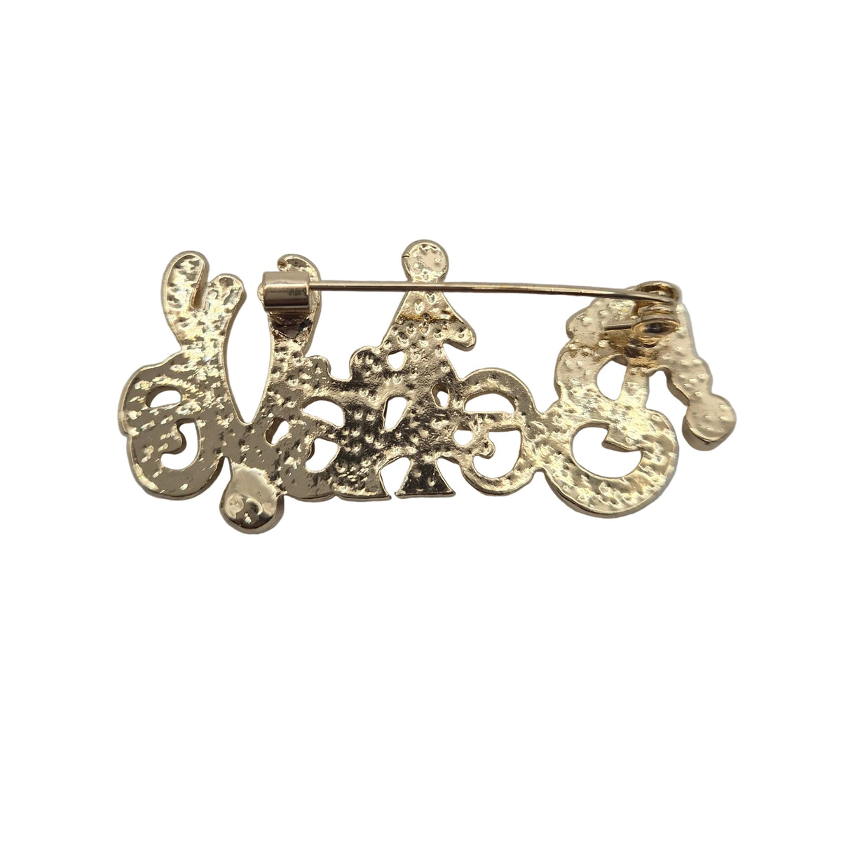 A Christmas brooch spelling the word believe, showing reverse gold side with pin mechanism. Displayed against a plain white background.