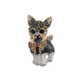 A small decorative cat-shaped brooch or charm with a black and white enamel body, gold-tone outlines, rhinestone detailing, and a bow motif on a plain white background.