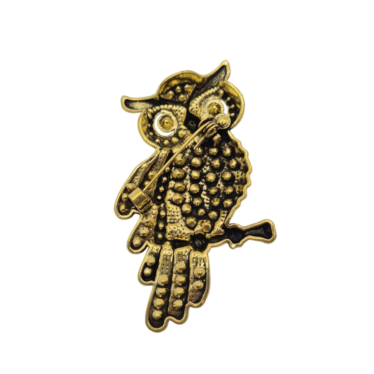 A small gold-toned bird-shaped accessory with textured dot detailing and dark recessed accents, photographed on a plain white background.