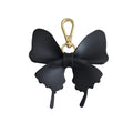 A black butterfly-shaped keychain or bag charm with a gold-tone lobster clasp, shown on a plain white background.