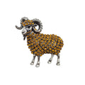 A ram-shaped brooch or pin featuring a silver-tone metal body and curved horns, covered with small round gold-tone rhinestones, shown on a plain white background.