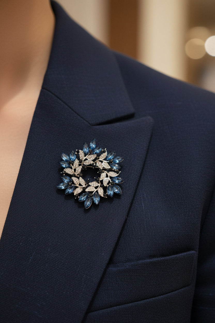 Blue and silver wreath brooch on a navy blazer