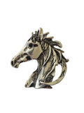 Silver horse head brooch on a white background