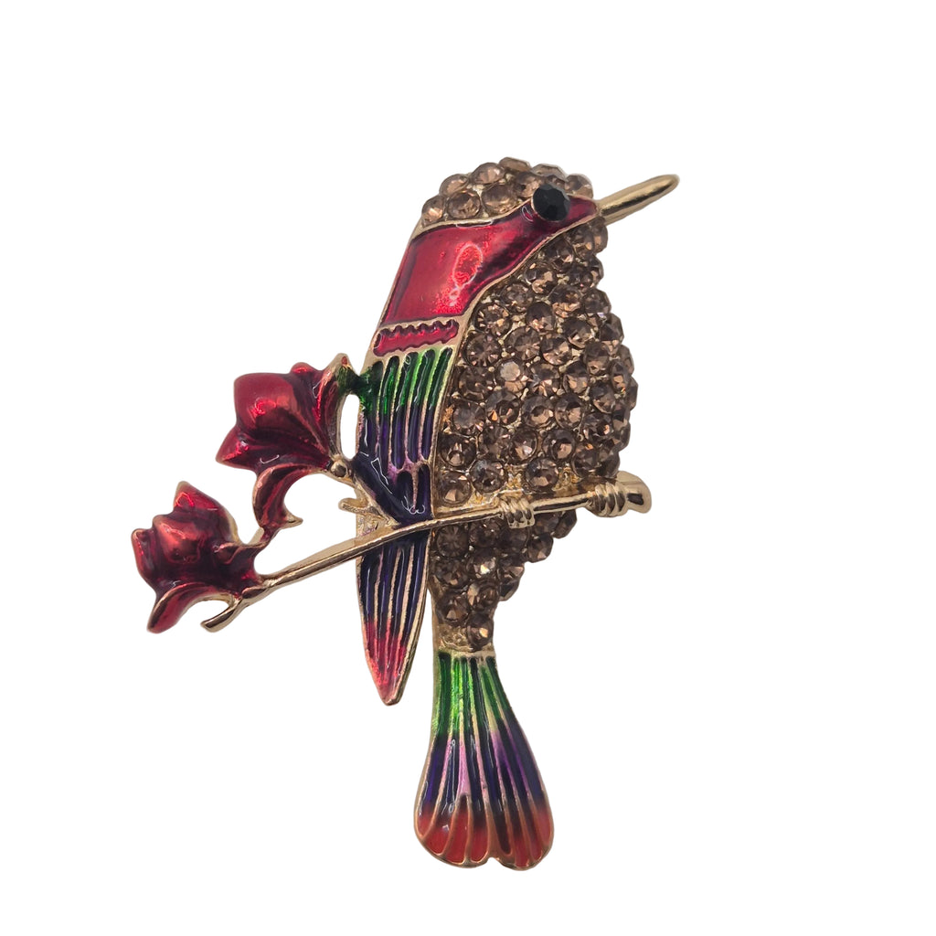 Colorful jeweled bird brooch on a gray background