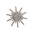 A silver-toned starburst brooch embellished with clear rhinestones, displayed on a white background.