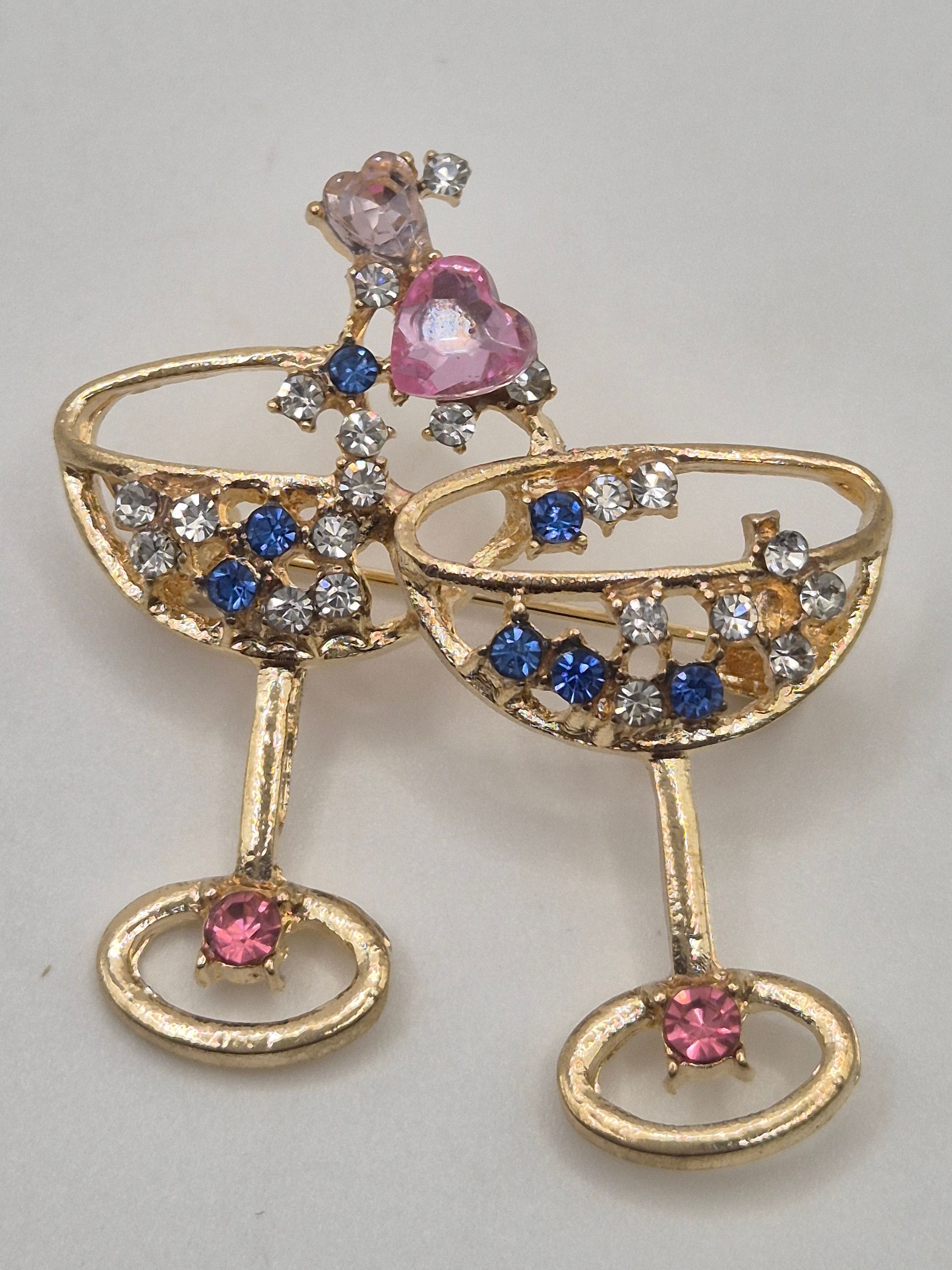 Gold brooch with gemstones on a light gray background