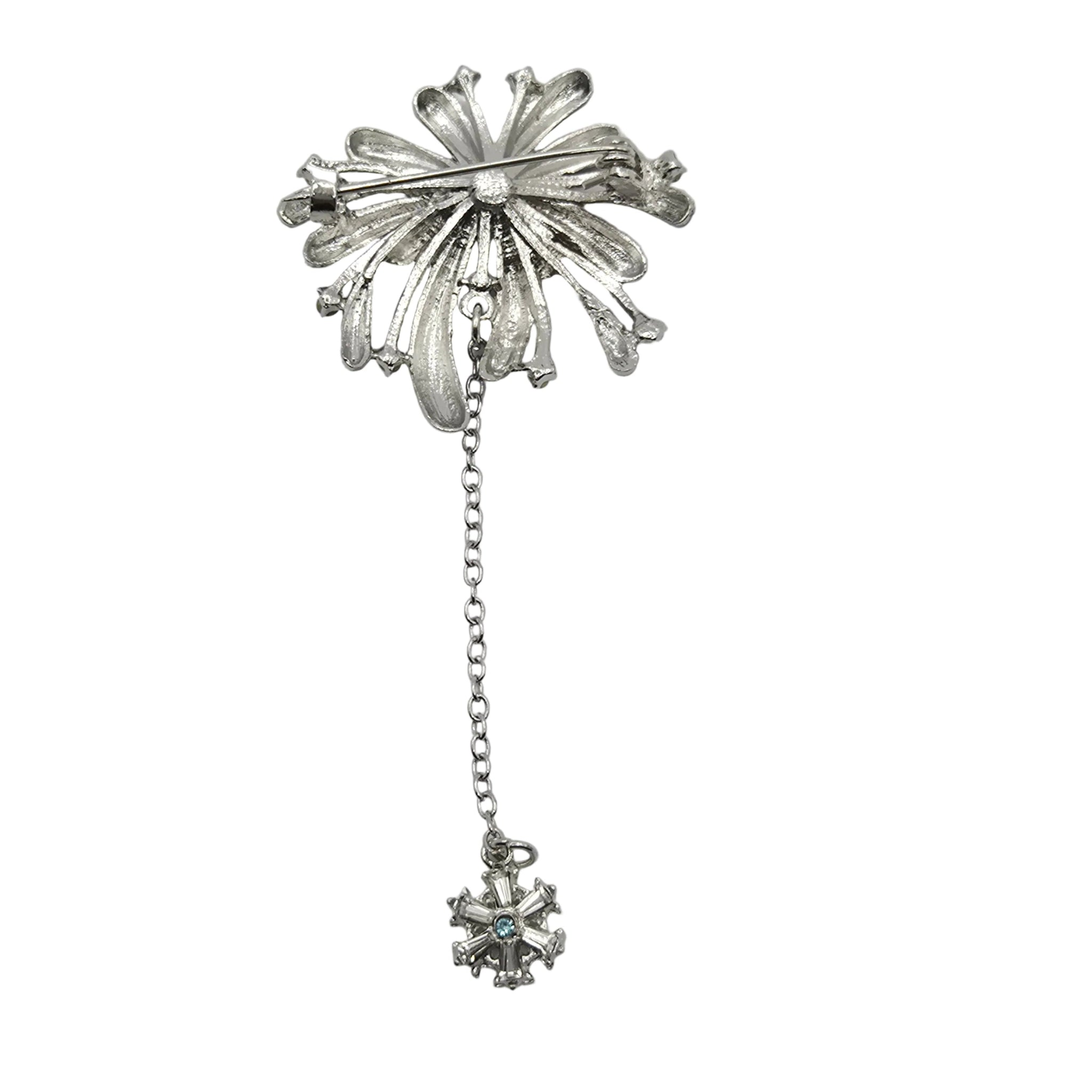 A gold-toned vintage firework brooch with a long chain and a small dangling star pendant, shown on a plain white background.
