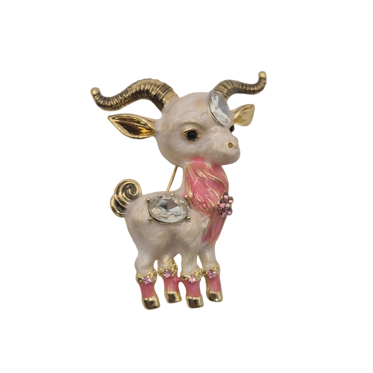 A decorative ram brooch with gold-toned horns and legs, a pink neck and tail accents, and a clear rhinestone on its forehead, shown on a plain white background.