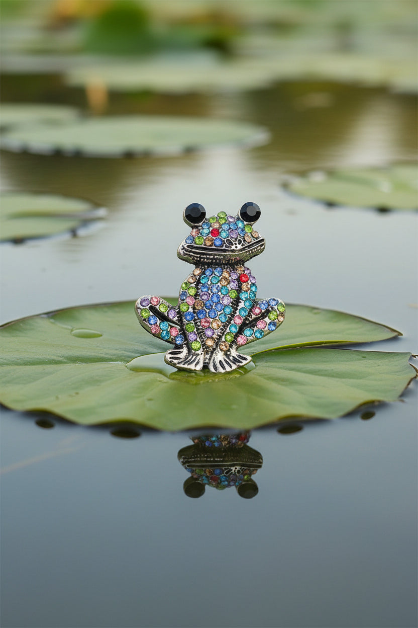 Rhinestone Frog Brooch with multicolored gemstones on a gray background
