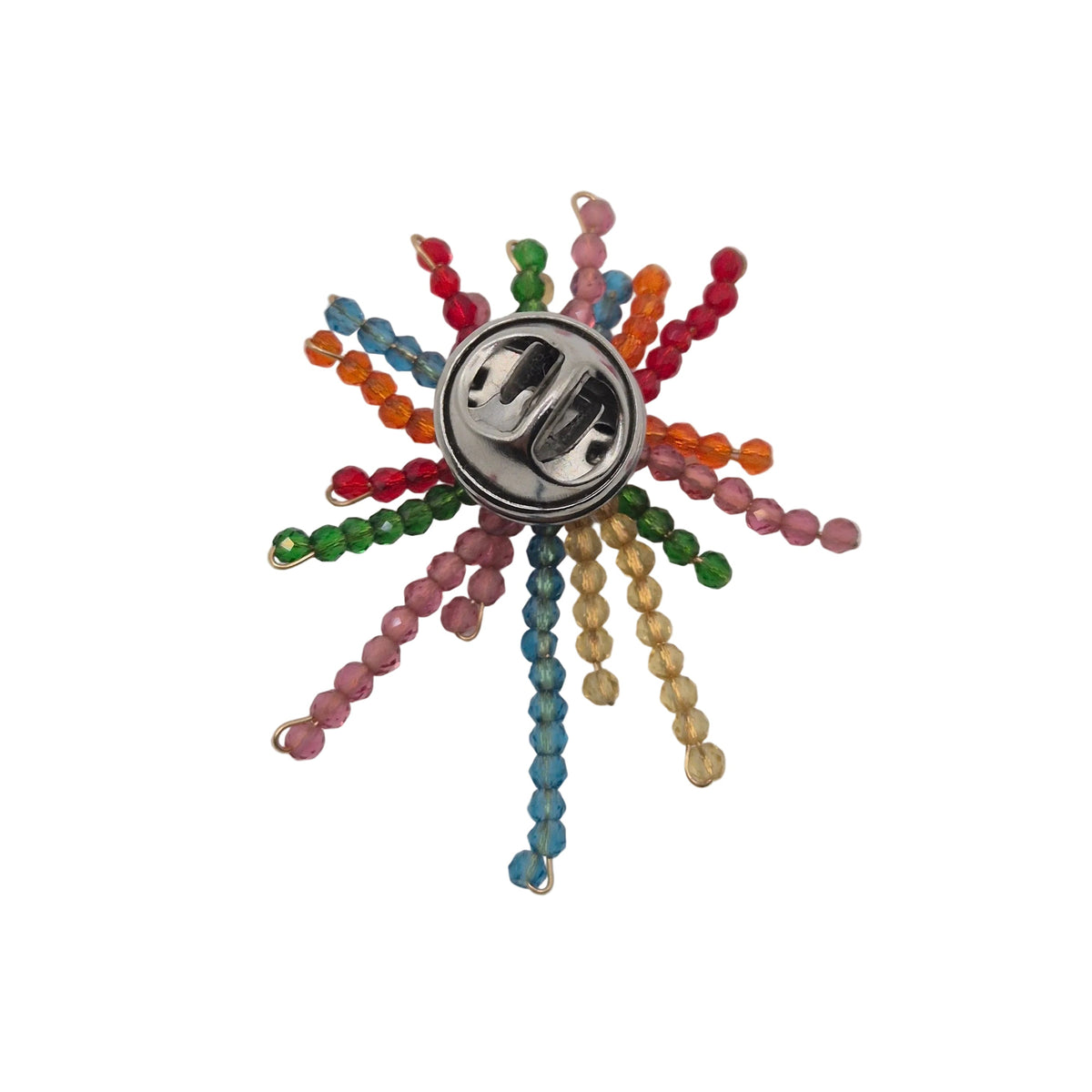 A colorful beaded firework brooch with a silver-tone metal center button, featuring multiple radiating strands of beads in pink, blue, green, orange, red, and gold on a plain white background.