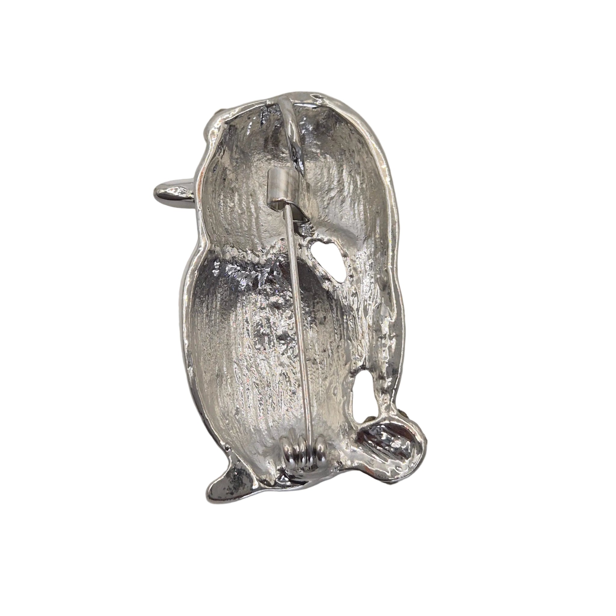 A penguin-shaped brooch shown on the reverse side. Displayed on a plain white background.