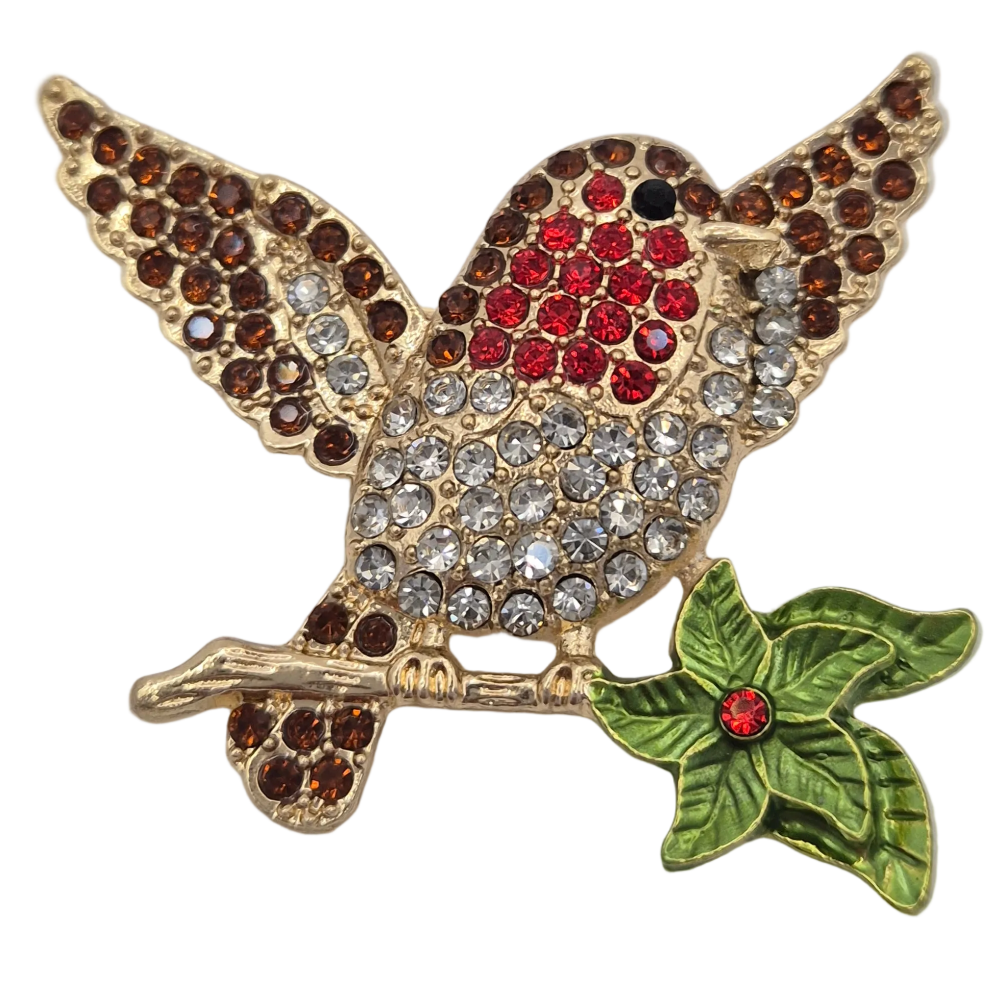 A gold tone robin bird brooch with wings spread, embellished with red and brown rhinestones, perched on a green leafy branch with a small red jewel accent, shown on a plain white background.