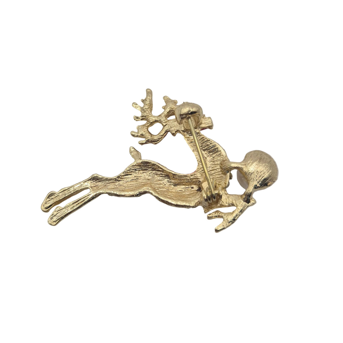 Reverse gold tone side of Christmas reindeer brooch showing pin mechanism, displayed against a plain white background.