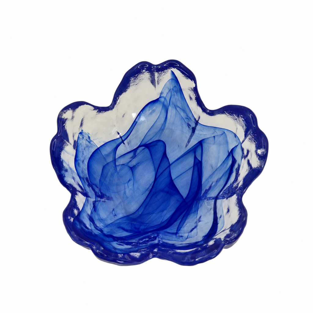 A cobalt blue and white patterned glass bowl or trinket dish with a scalloped rim, photographed from directly above on a solid white background.
