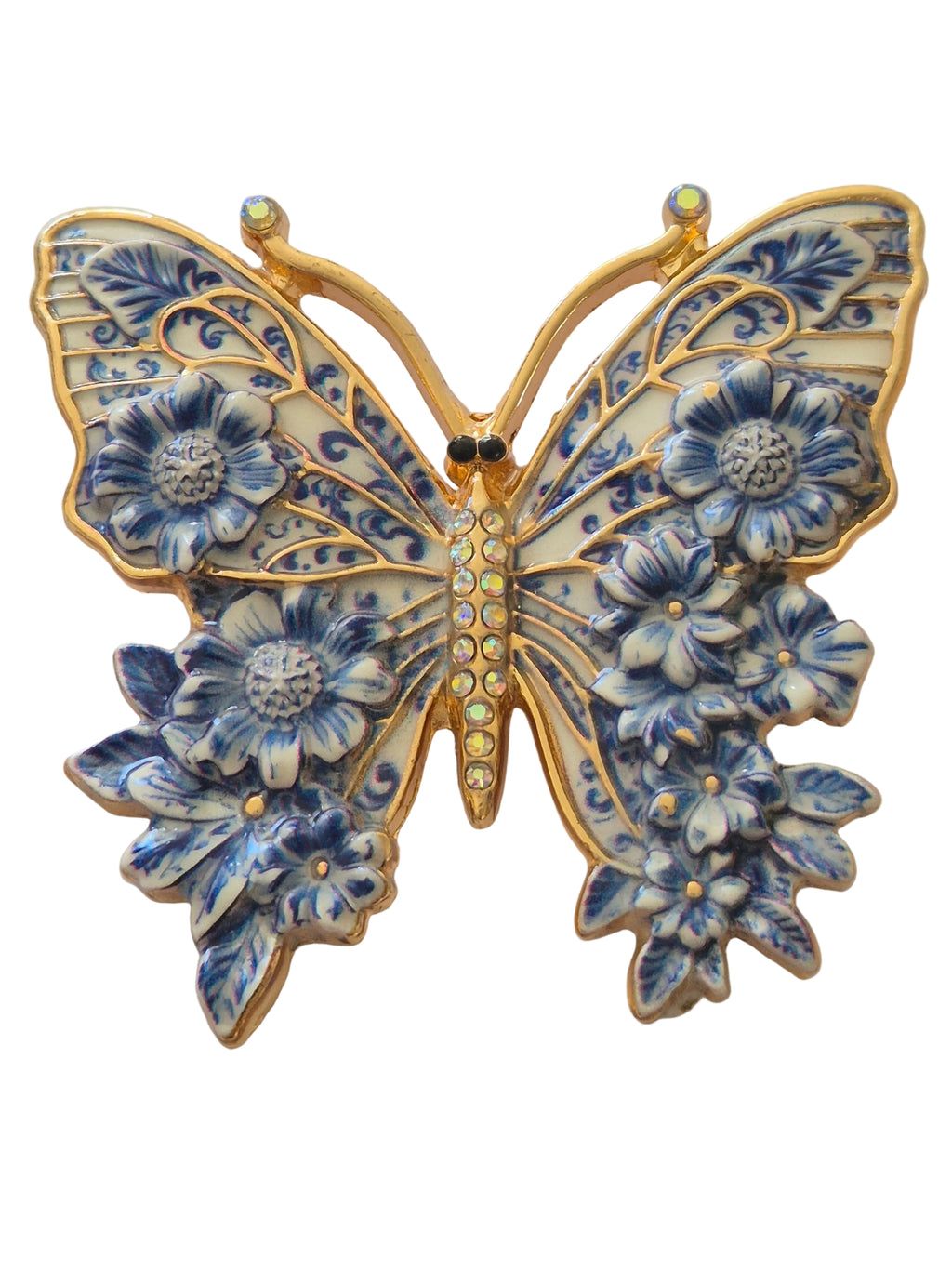 Decorative butterfly brooch with blue floral patterns and gold accents on a white background
