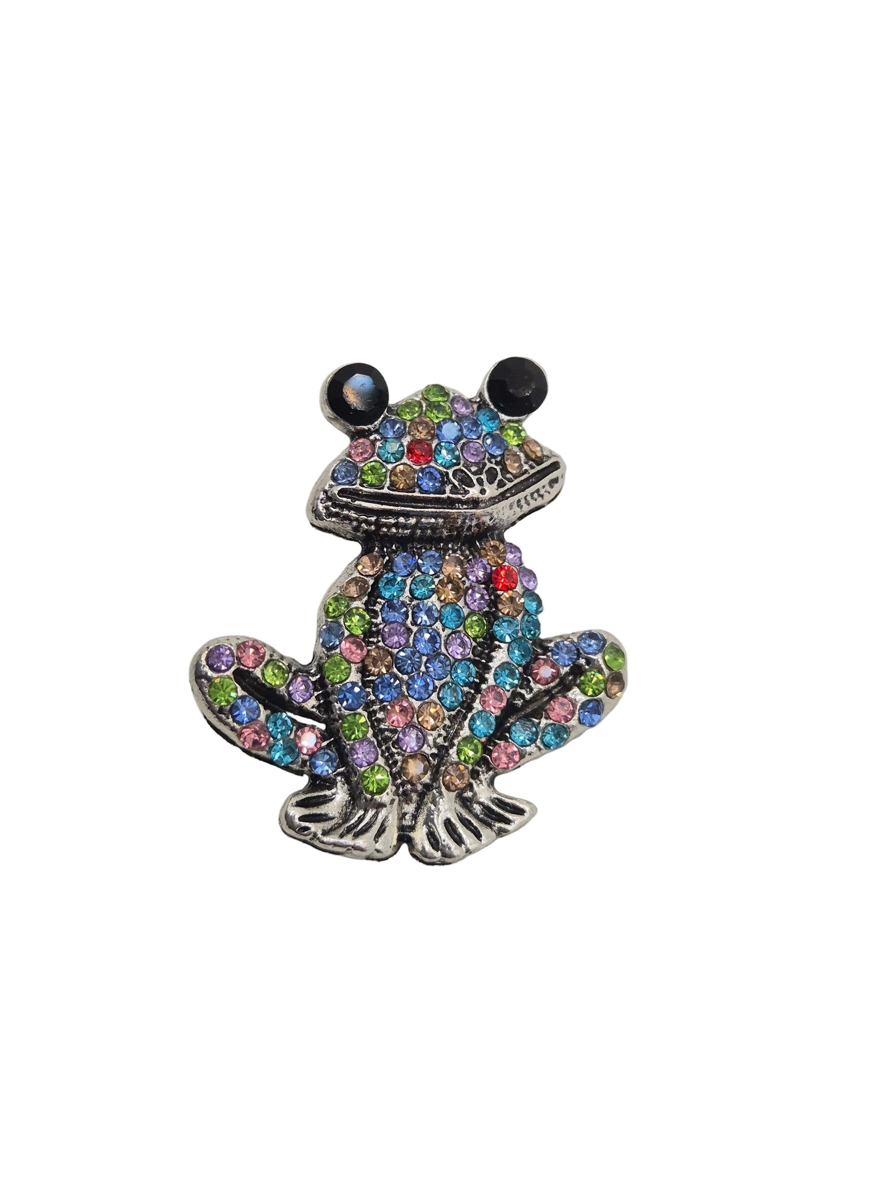 Rhinestone Frog Brooch with multicolored gemstones on a gray background