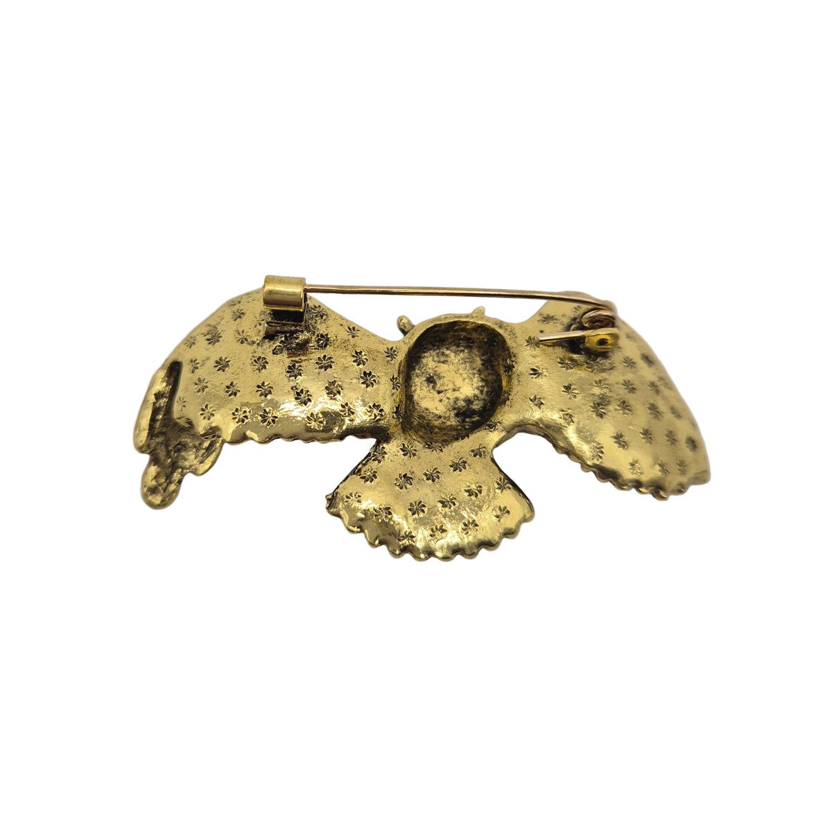 Reverse gold tone side of an owl brooch pin showing the pin mechanism, shown against a plain white background.
