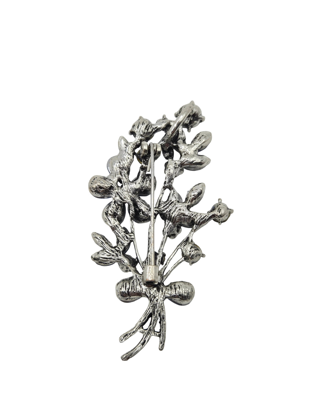 Silver blue brooch with intricate design on a gray background
