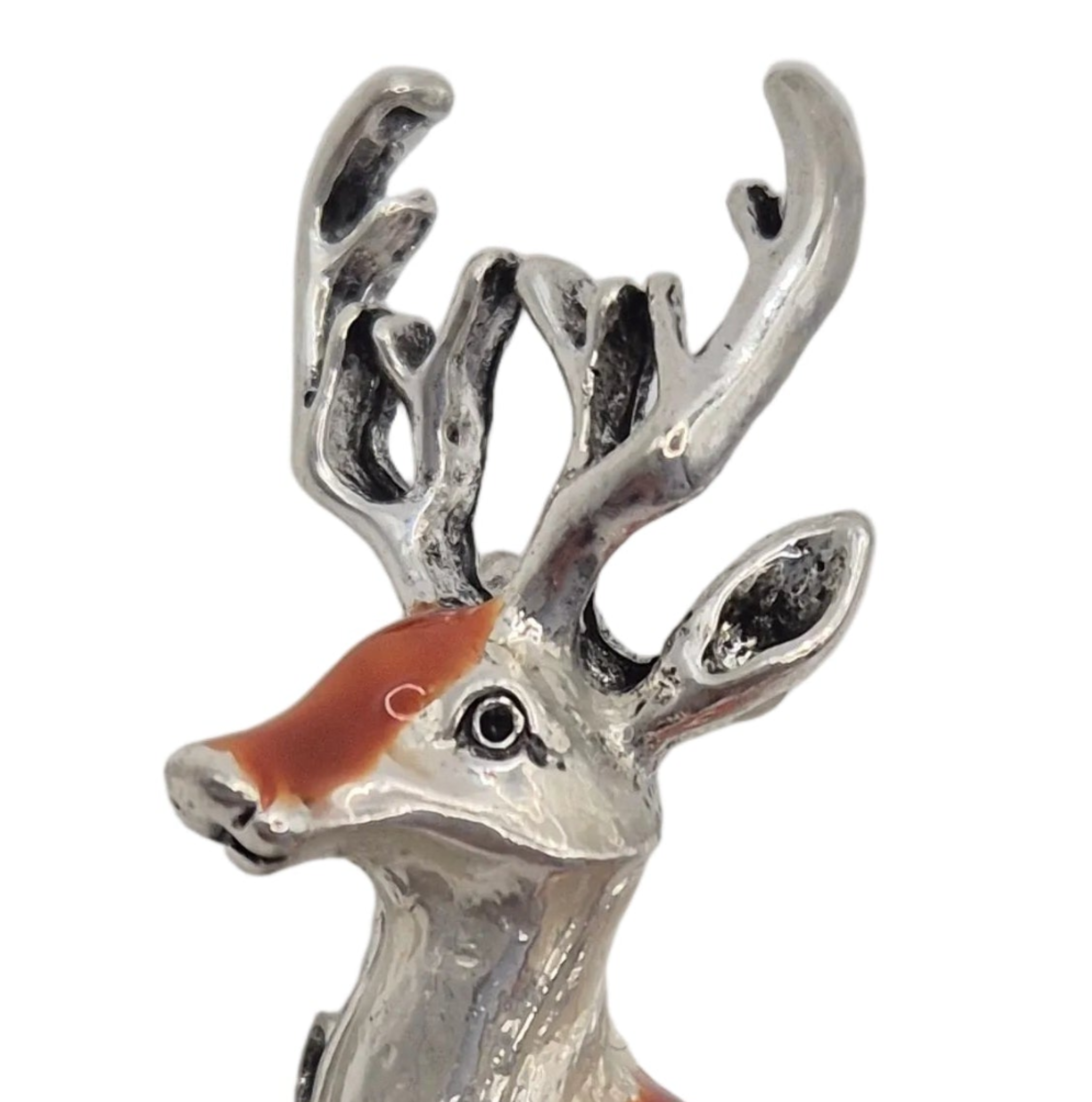 A deer-shaped brooch or pin with a silver-tone metal body, featuring an orange-brown enamel body with white spots and a small orange-brown tail, set against a plain white background.