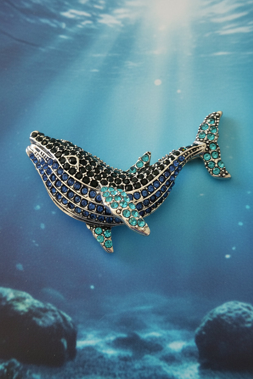 Blue rhinestone whale brooch with blue background