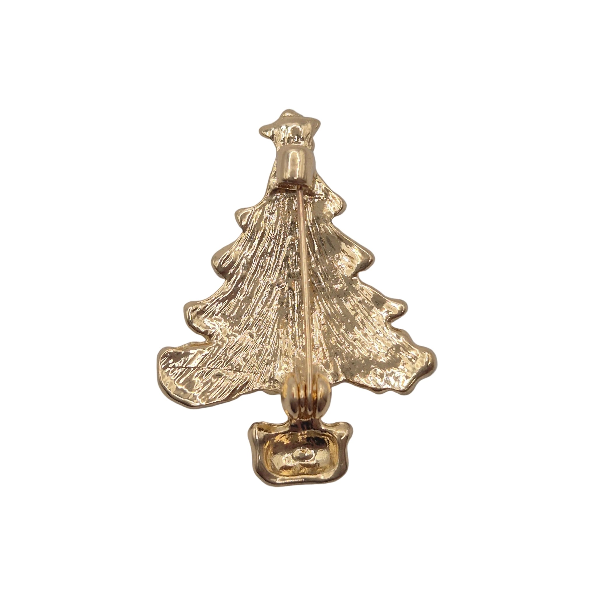 A small gold Christmas tree brooch with a textured, hammered finish, shown on a plain light white background.