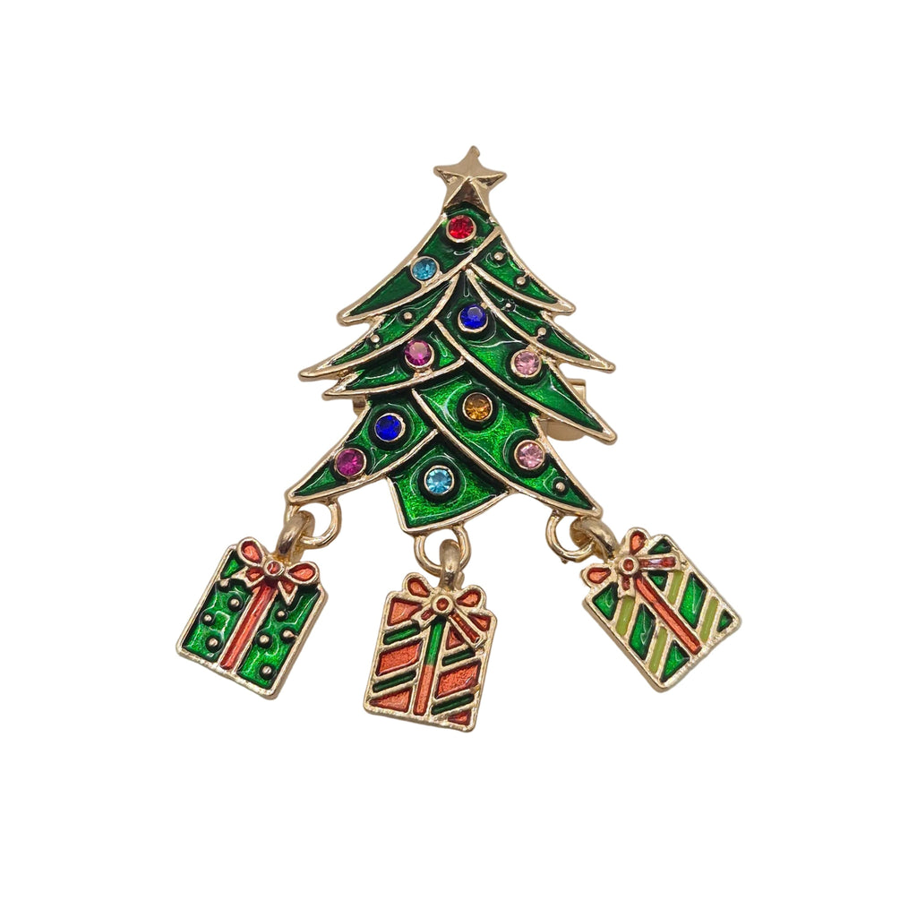 A gold-tone Christmas tree charm brooch with green enamel, colourful rhinestone accents, and three hanging gift box charms, shown on a plain white background.