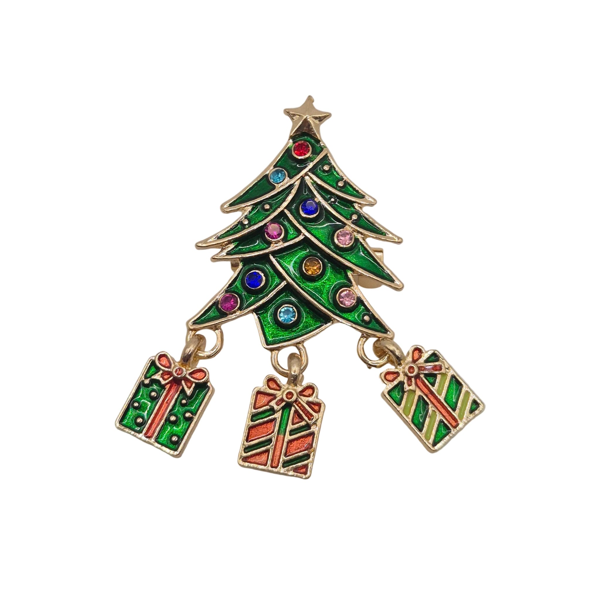 A gold-tone Christmas tree charm brooch with green enamel, colourful rhinestone accents, and three hanging gift box charms, shown on a plain white background.