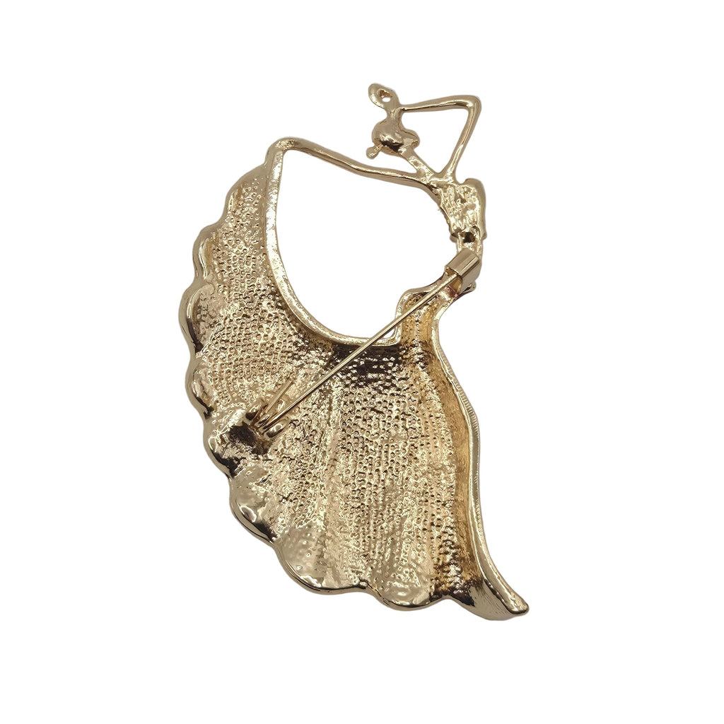 A gold tone dancing figure brooch showing the reverse side, displayed on a plain white background.