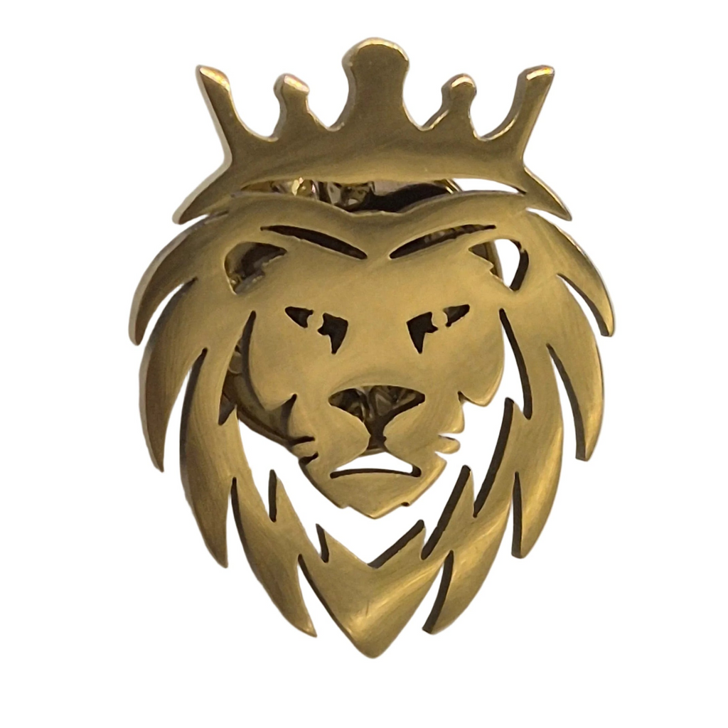 A gold lion head brooch featuring a crown on top, shown against a plain white background.