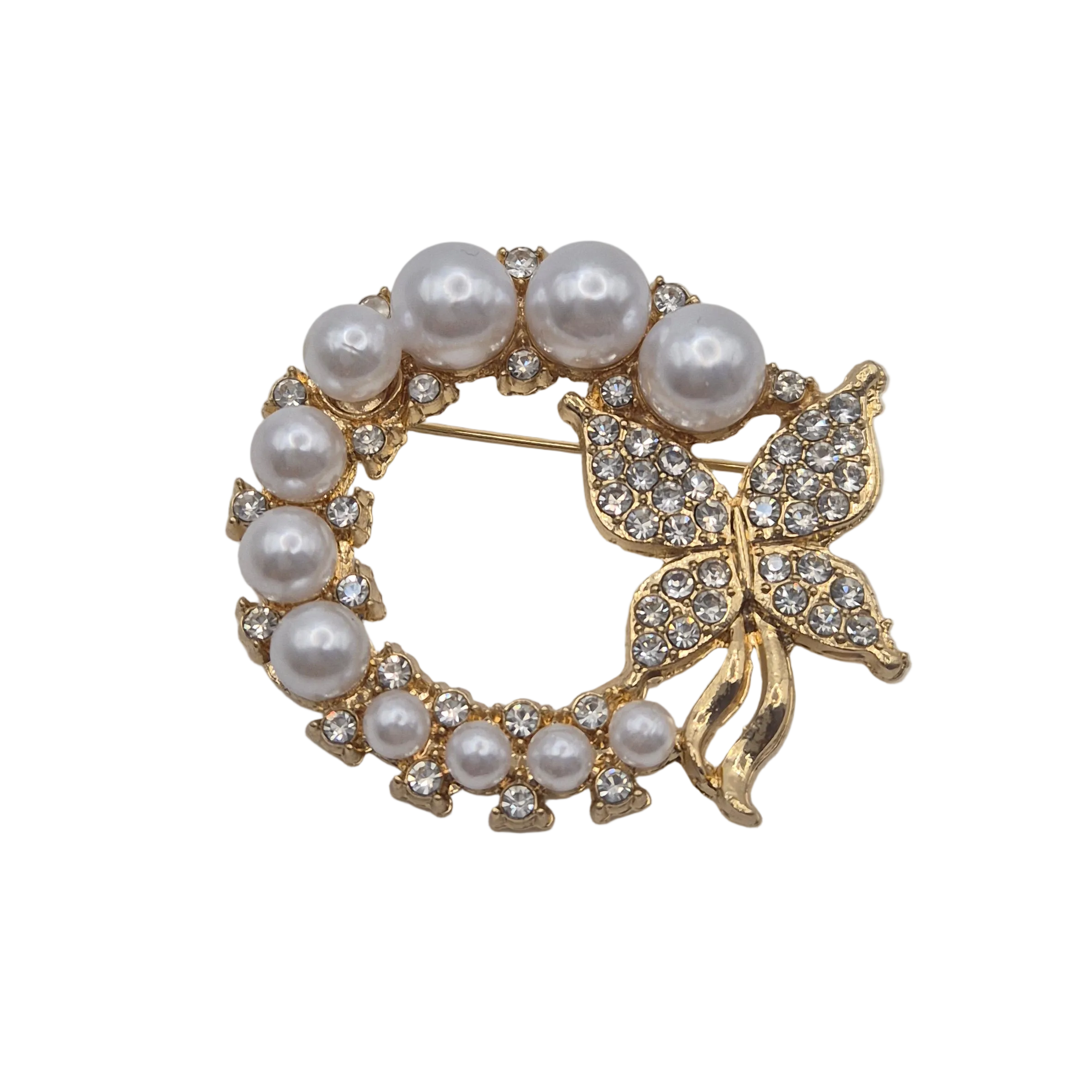 A gold butterfly and ereath design brooch decorated with white faux pearls and clear rhinestones, set against a plain white background.