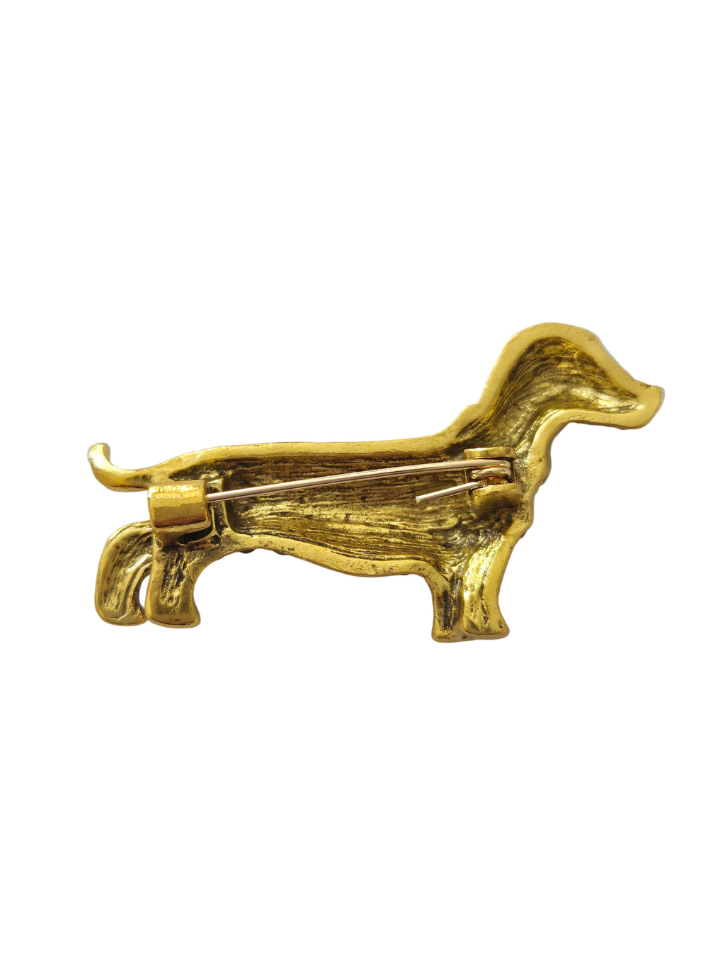 Gold  dachshund dog brooch on a light gray background
