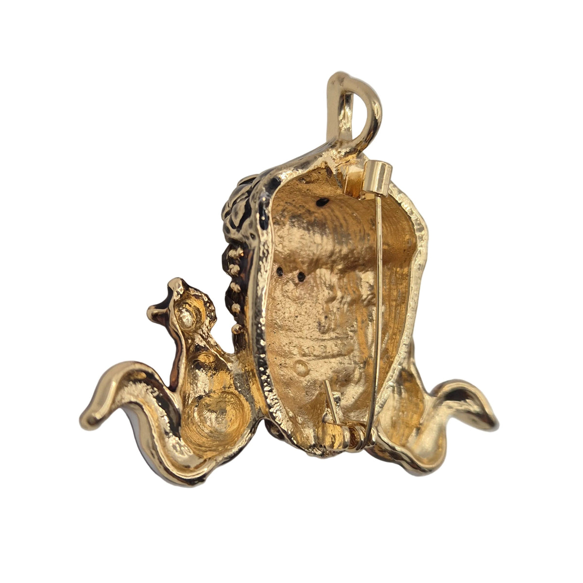 A vintage-style gold tone brooch or pendant featuring two small squirrels flanking a large acorn, shown from reverse side shown against a plain white background.