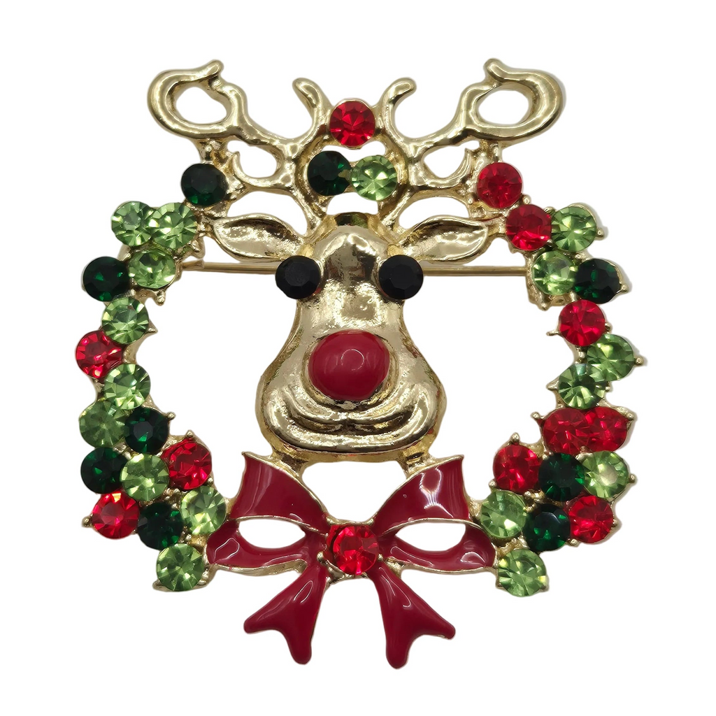 A gold-tone reindeer nose brooch decorated with a green and red rhinestone wreath and a red bow, shown on a plain white background.
