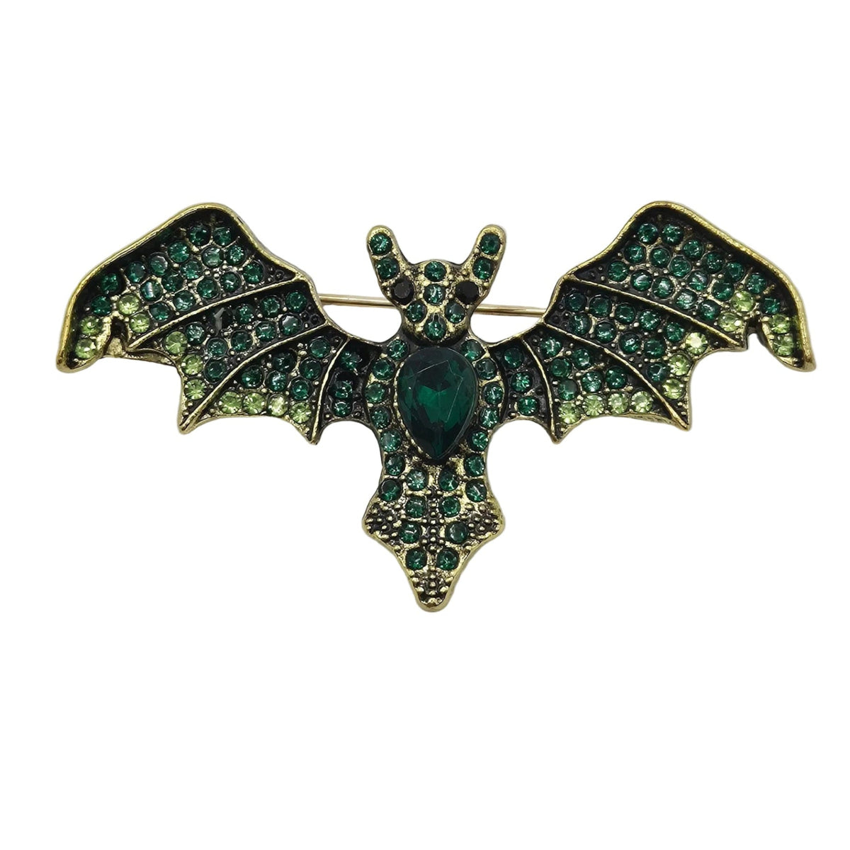A vintage bat-shaped brooch featuring green enamel wings and body with gold-tone metal outlines and rhinestone accents, displayed on a neutral white background.