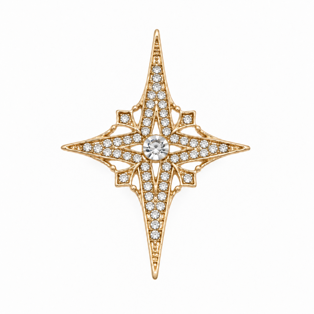 Gold tone four point star brooch with clear rhinestone detailing, displayed against a plain white background.