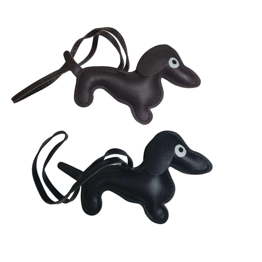 Two faux leather dachshund-shaped keychains with matching key loops, shown on a plain white background.