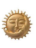 Gold sun and moon face brooch on a white background