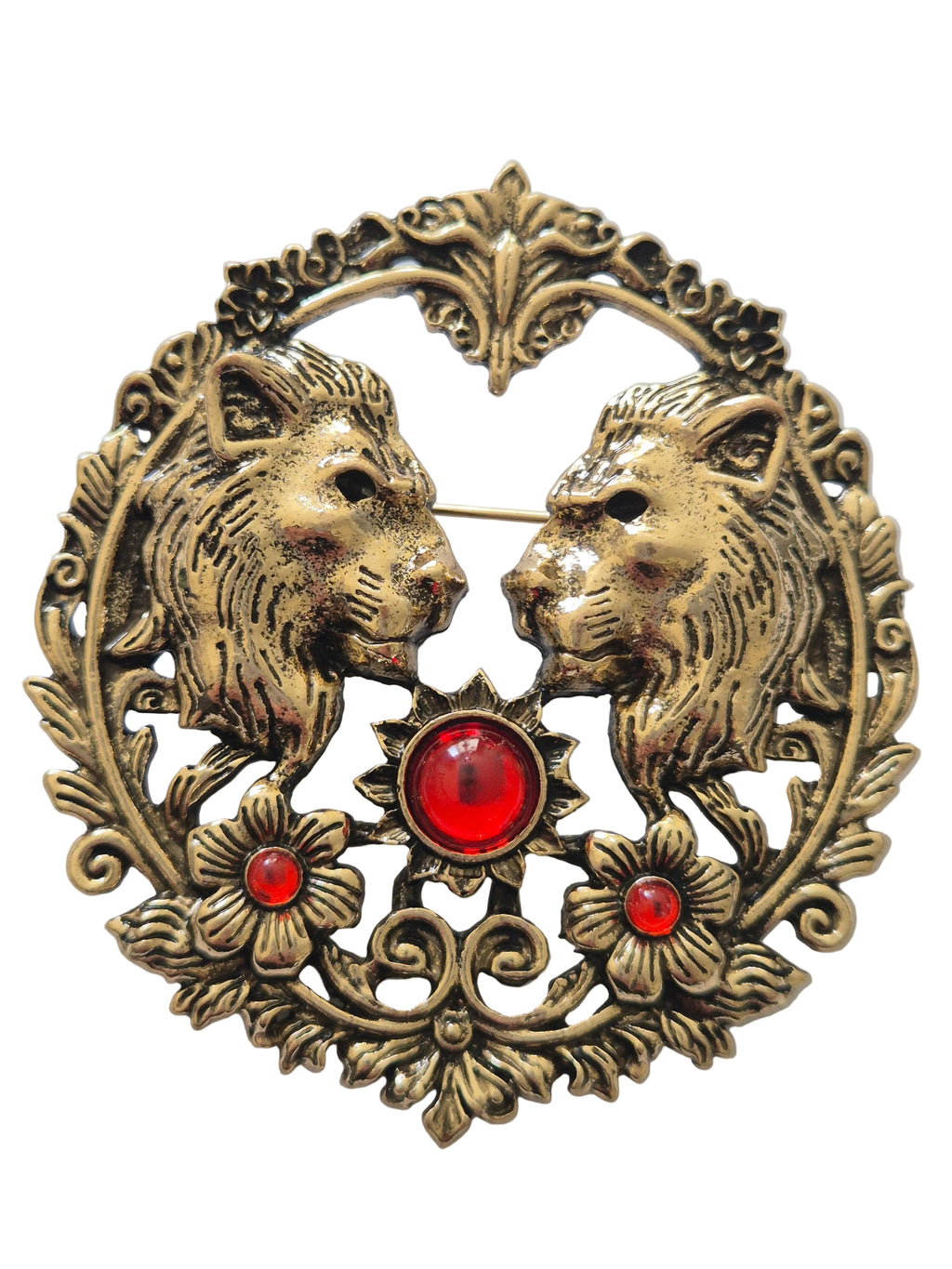 Decorative brooch with lion design and red gemstones on a light gray background