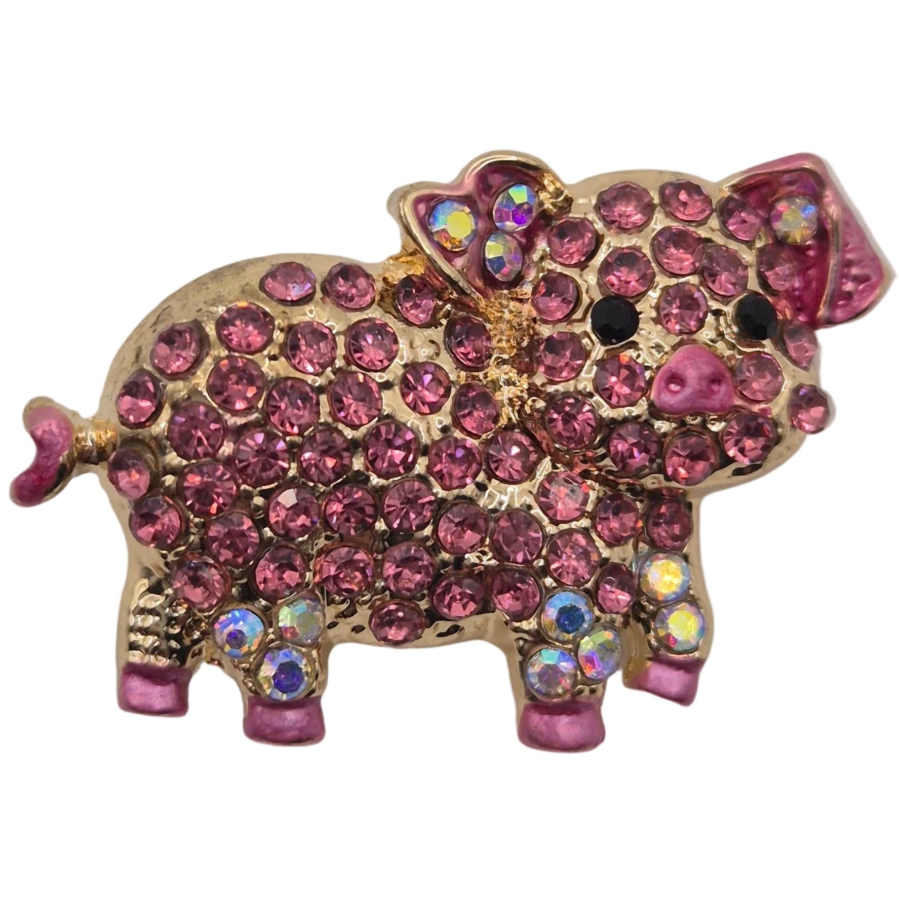 Pink and gold pig-shaped brooch with gemstones on a white background