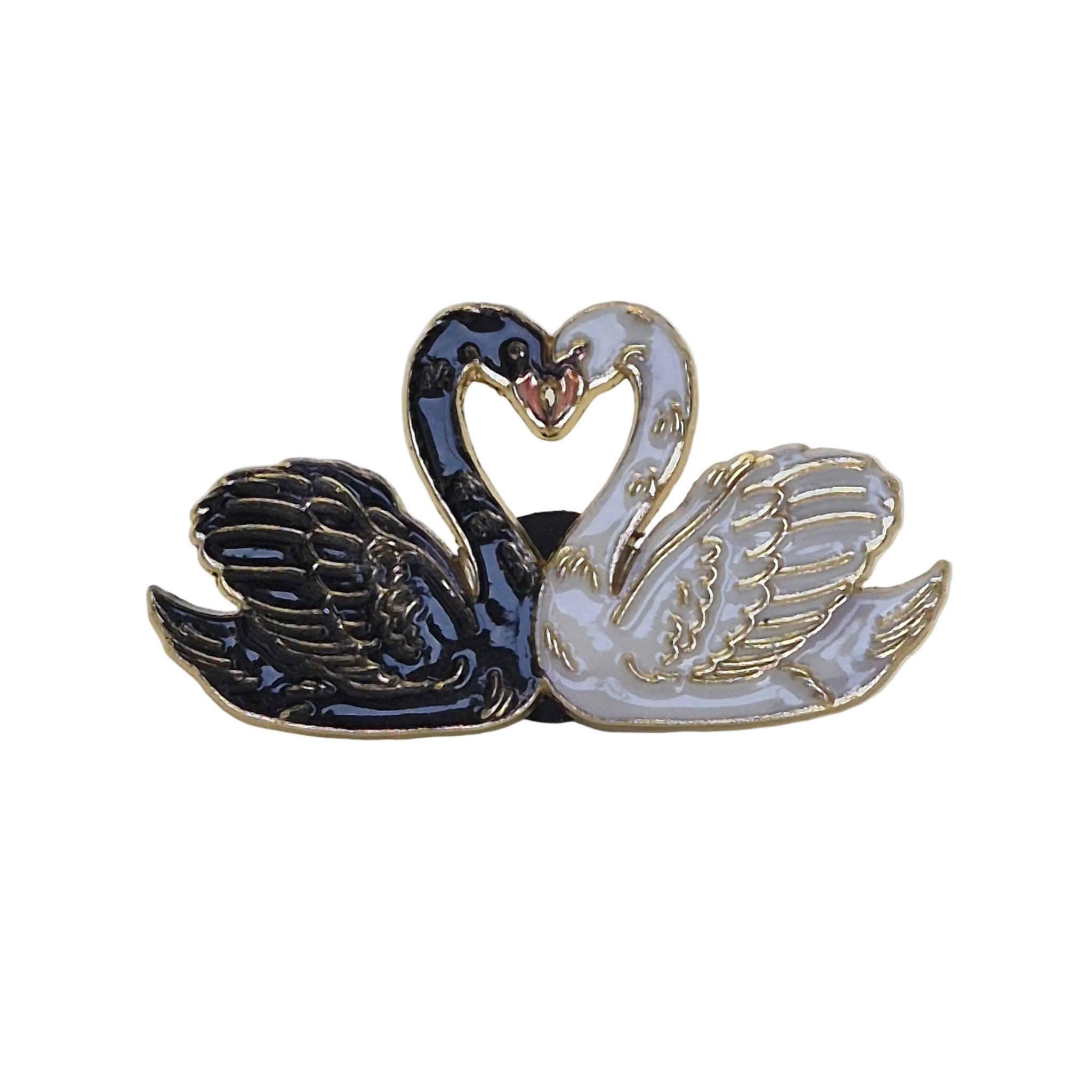 A twin swan enamel lapel pin featuring one black swan and one white swan facing each other to form a heart shape with their necks, outlined in gold-tone metal.