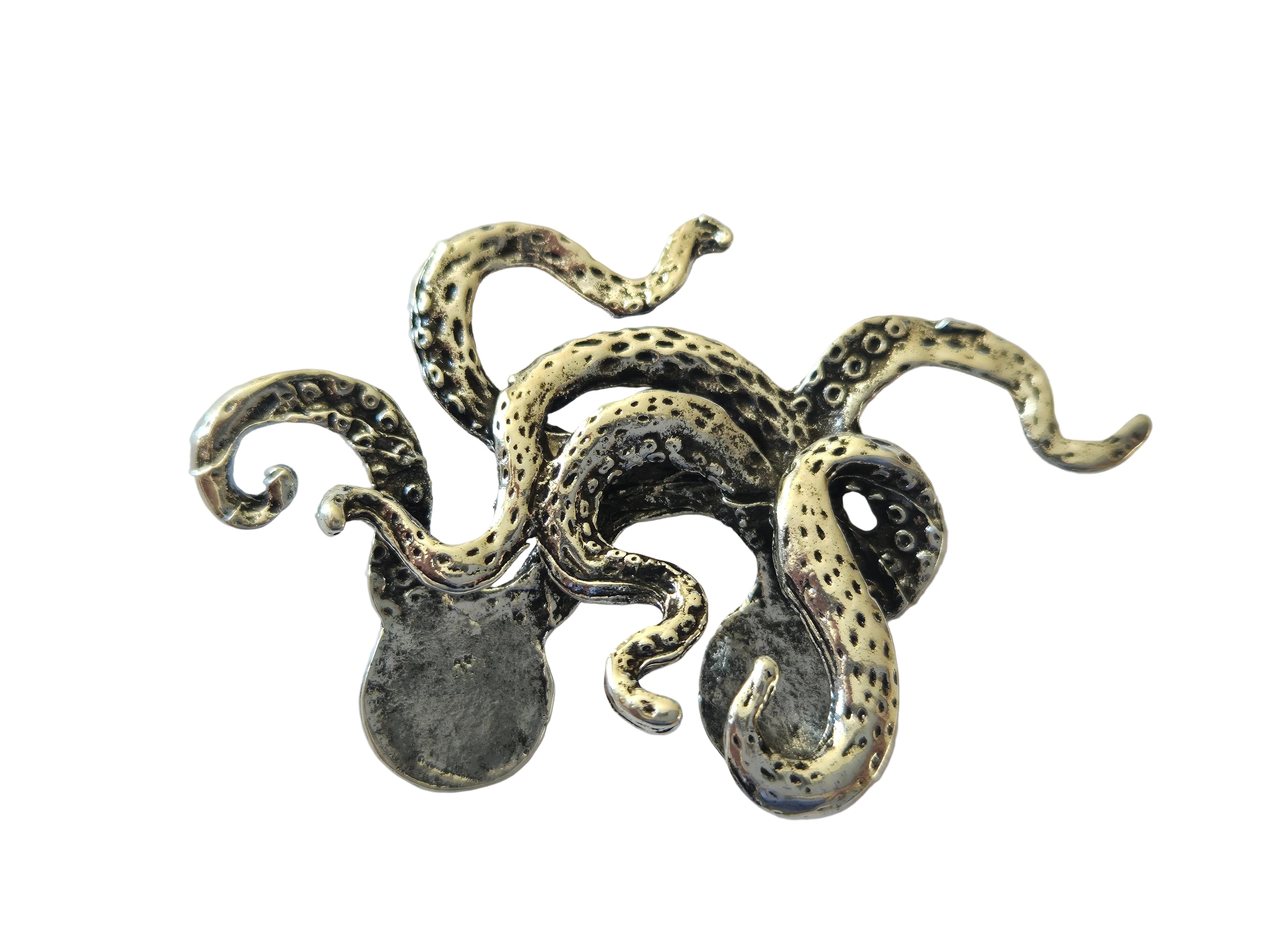 Silver octopus charm brooch on a light gray background