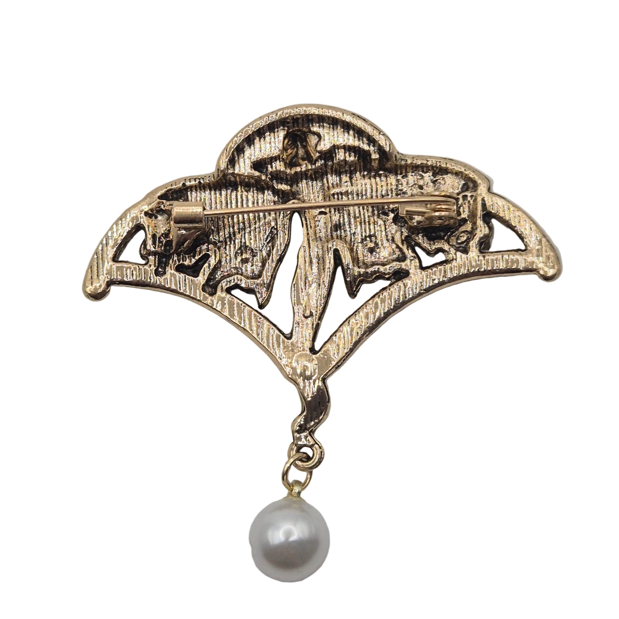 An antique-style gold brooch featuring a stylized fairy with a dangling pearl, shown against a plain white background.