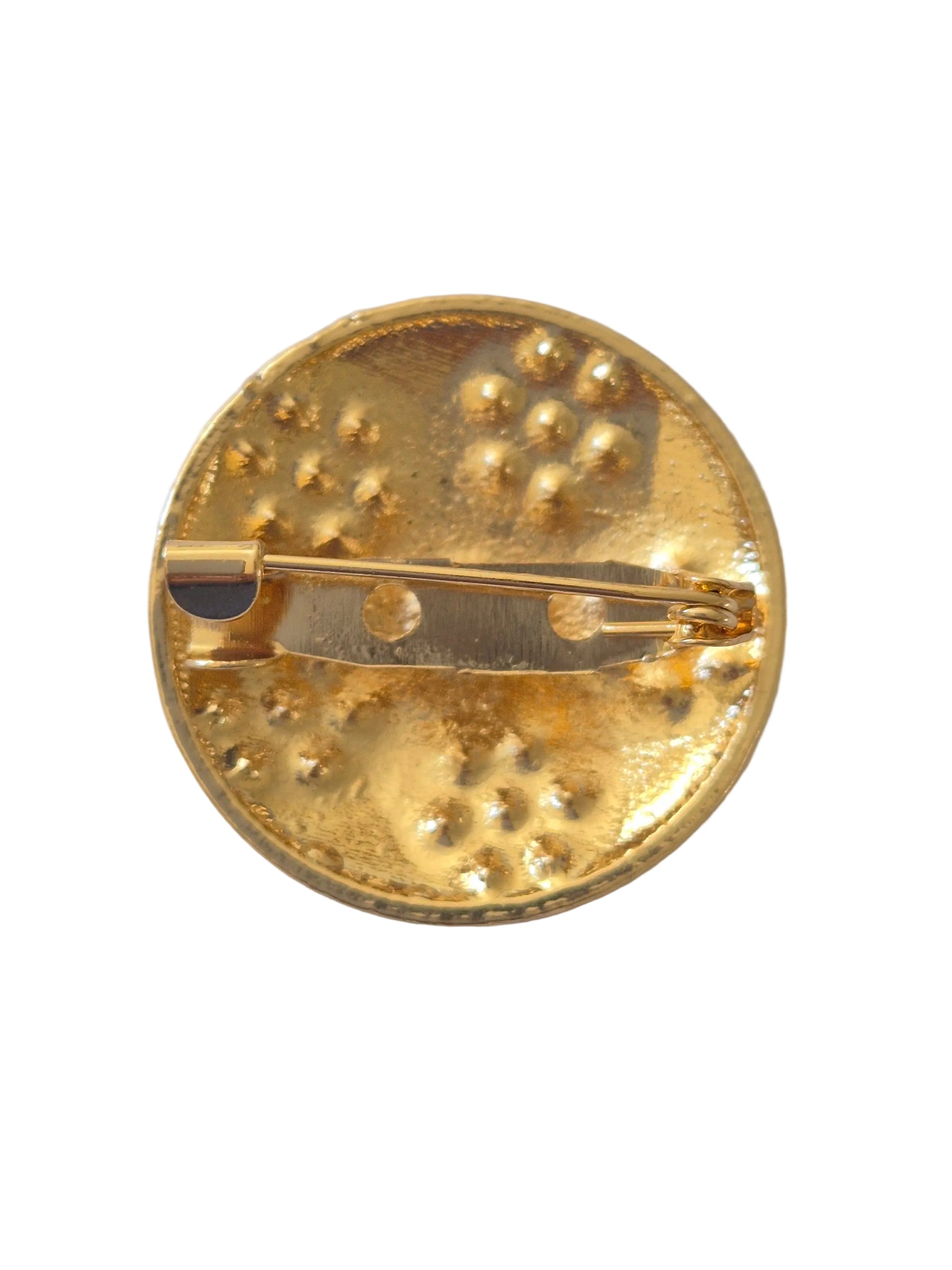 Rhinestone football brooch with gold and black detail on a white background.