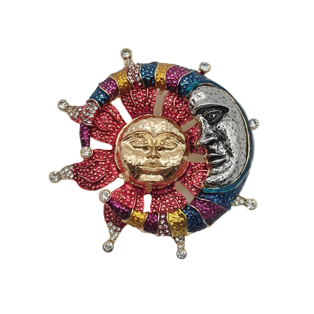 A colorful enamel brooch featuring a gold sun face surrounded by red, pink, blue, and purple rays, alongside a silver crescent moon face, set against a plain white background.