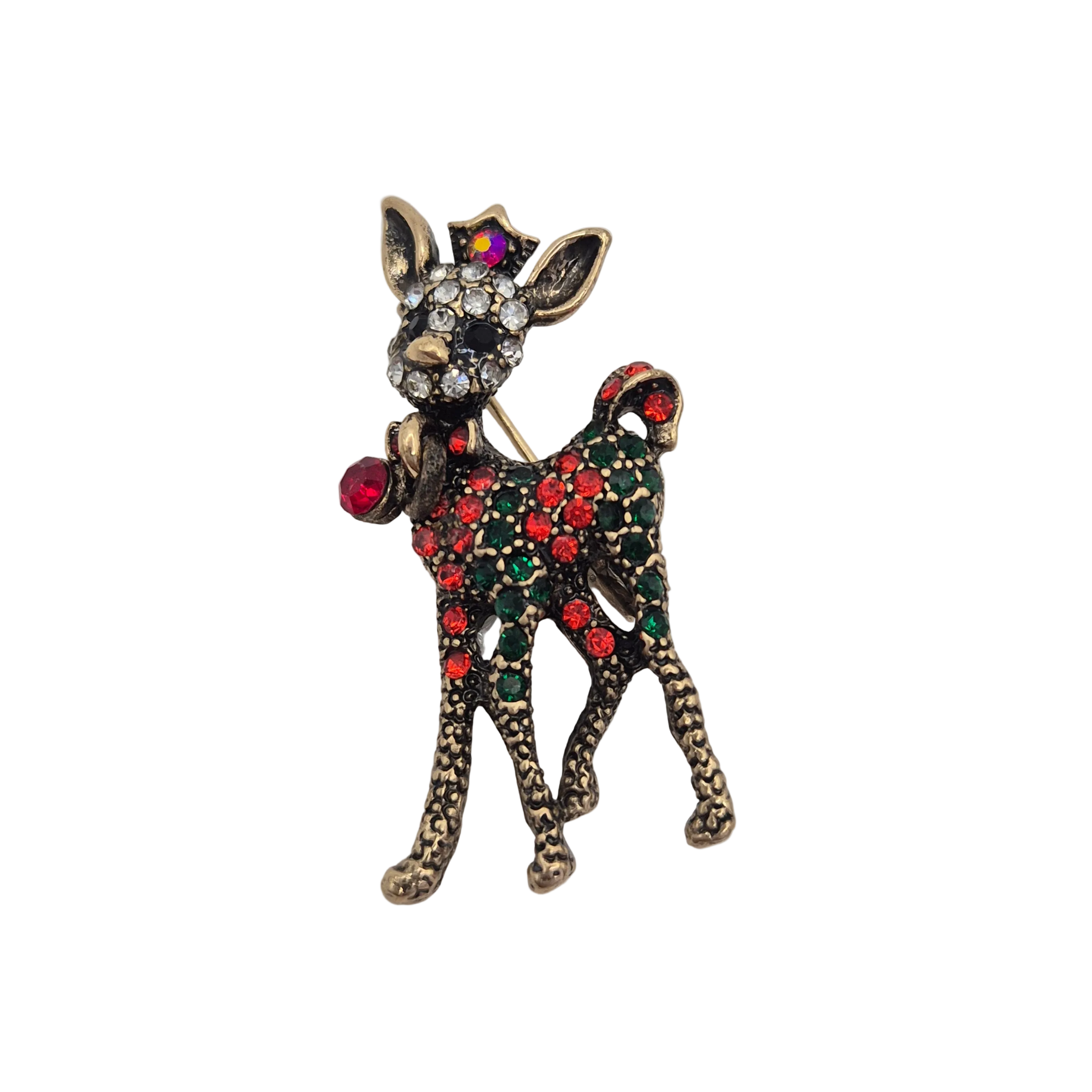 A decorative reindeer-shaped brooch with an antiqued gold-tone metal finish, embellished with red and green rhinestones and a clear crystal face, photographed on a plain light background.