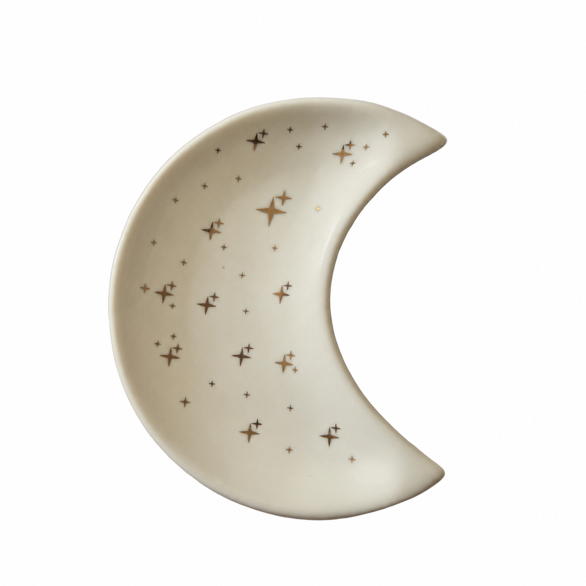 A white crescent moon shaped ceramic crescent moon trinket dish decorated with metallic goldstars, displayed against a plain white background. 