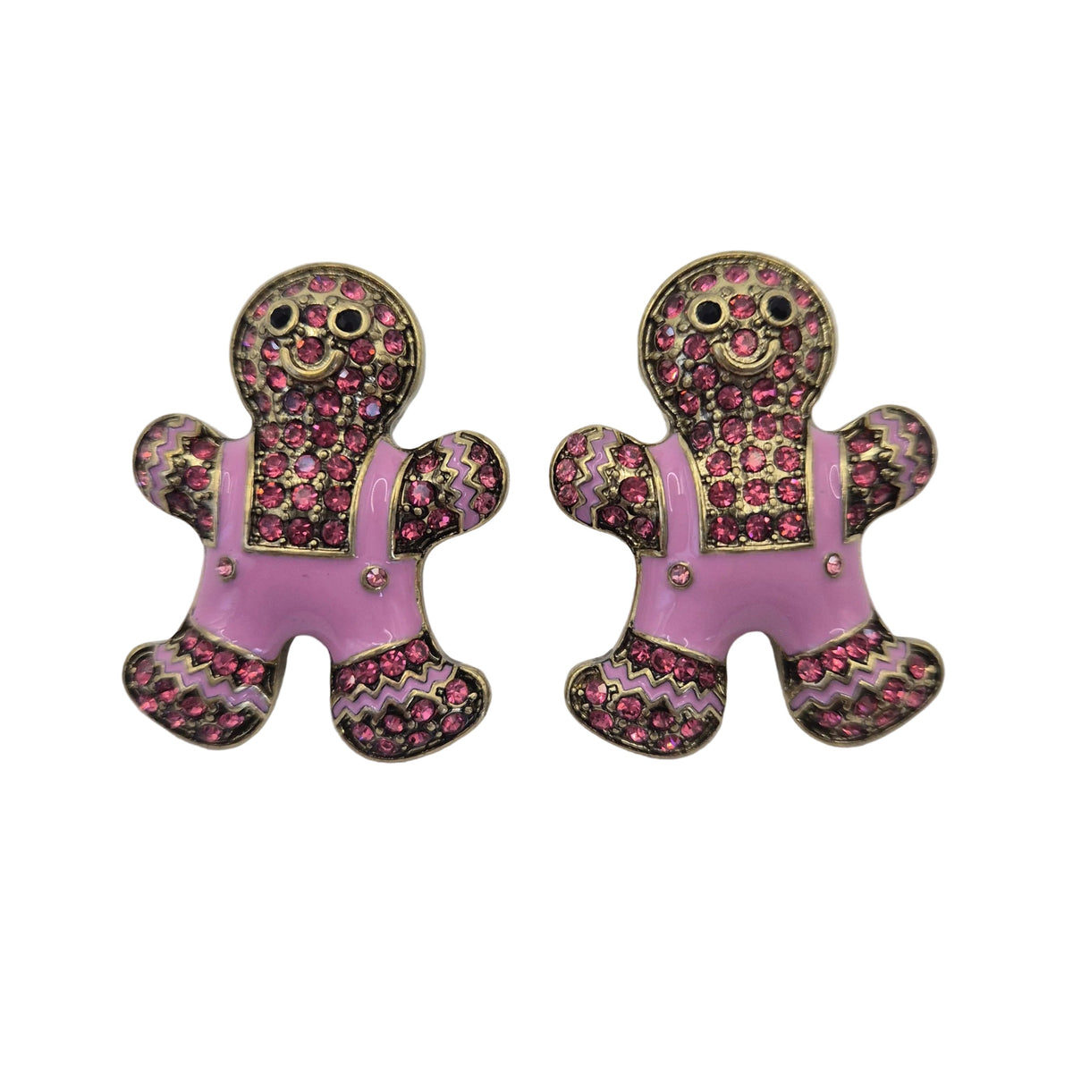 A pair of gingerbread man stud earrings with pink enamel overalls and a pink, purple, and gold glittery patterned body, shown on a plain white background.