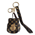 A small brown and gold mini bag keychain with a gold-tone clasp and a matching wristlet strap, shown on a plain white background.
