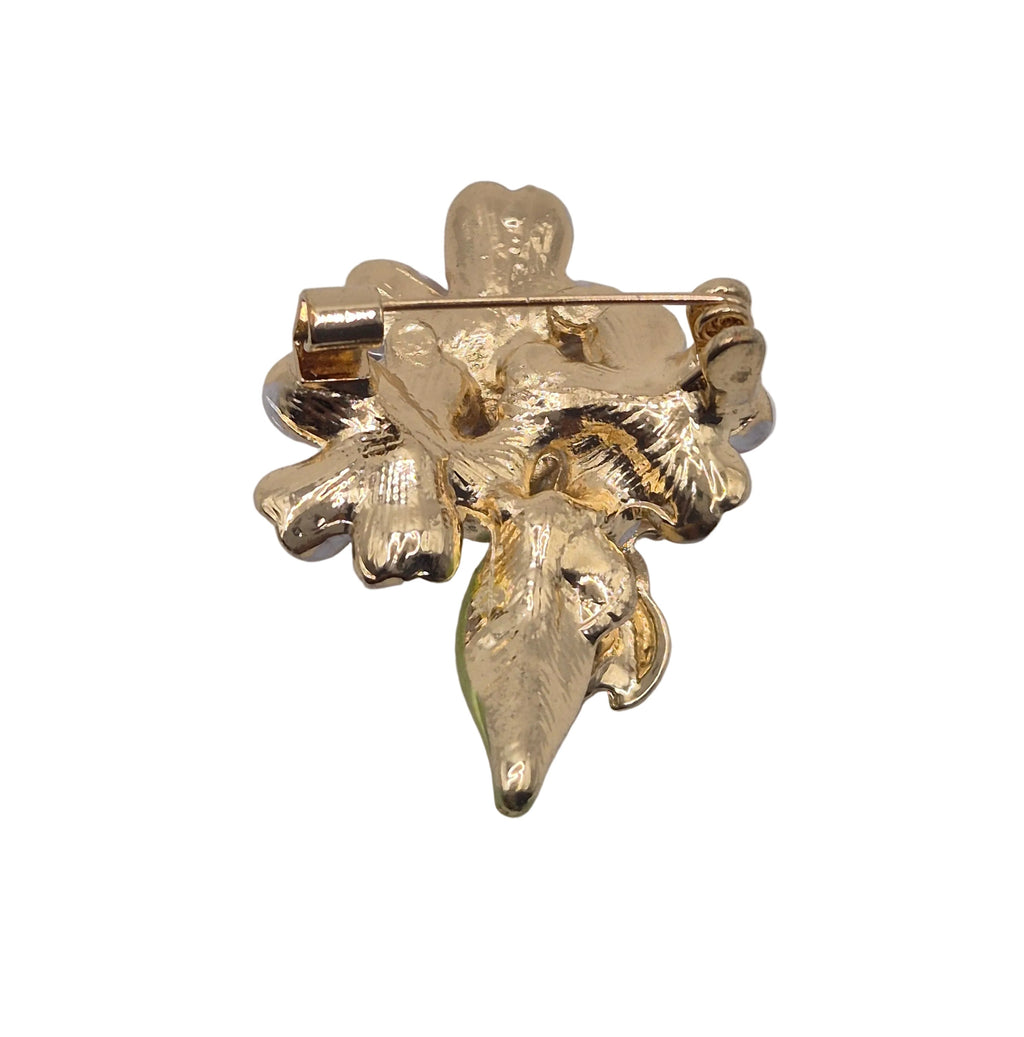 A gold-tone floral brooch featuring textured leaf and flower details with a pin clasp, shown against a plain white background.