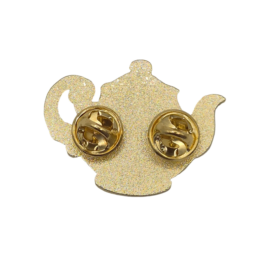Gold glitter teapot-shaped pin with gold-tone metal clutch backs, shown from the back on a white background.